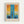 May include: Framed abstract art print in light wood frame hanging on white wall. Artwork features vertical blue brushstrokes down center with orange and yellow paint in upper corners, white middle band, and darker blue lower section. French text above reads "Réflexions insairées par les tableaux de Mark Rothko" with artist name and quote below in black text on cream background.