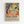 May include: Framed art poster mounted on white wall featuring colorful abstract landscape with orange sun, green foliage, blue tree trunks, coral ground with scattered yellow circles, in vibrant Fauve painting style. Natural wood frame surrounds artwork with exhibition text below describing Henri Matisse's revolutionary use of color and artistic influence.