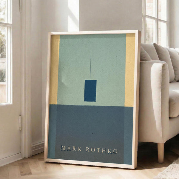 May include: Framed abstract art print with sage green upper section, darker teal lower section, yellow side panels, and suspended dark blue rectangle. Light wood frame leaning against white wall beside beige upholstered sofa in bright, windowed living room with hardwood floors.