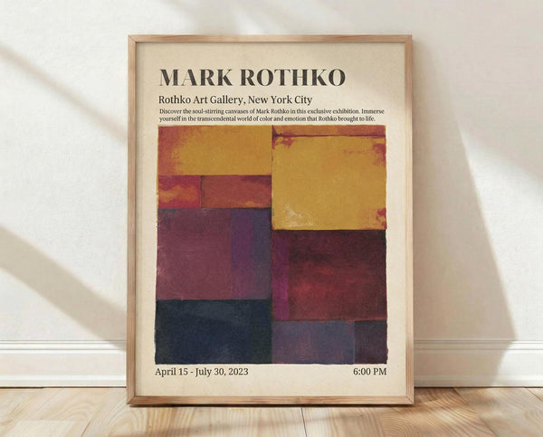 May include: Framed exhibition poster featuring Mark Rothko's name in bold black letters at top, with colorful abstract color block artwork below in warm yellows, deep reds, purples, and dark blues arranged in rectangular segments. Poster shows gallery details and exhibition dates. Light wood frame sits on wooden floor against white wall with soft natural lighting and shadows.