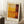 May include: Framed abstract art print with warm orange, yellow, and deep burgundy color blocks in Rothko's signature style, displayed in light wooden frame against white wall. Scene shows cozy interior with coffee cup on wooden block side table and soft beige textiles nearby.