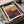 a framed poster or artwork with a colorful abstract design, placed in a cardboard box.
