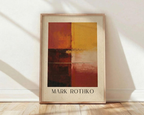May include: Abstract art poster print in wooden frame leaning against white wall on light wood floor. Artwork features six rectangular color blocks in warm earth tones - burnt orange, golden yellow, deep burgundy, cream, and reddish-brown arranged in grid pattern. Text reads "Mark Rothko" below the image on cream-colored background with vintage texture.