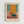 May include: Framed abstract art print hanging on white wall featuring geometric blocks of orange, teal blue, and coral pink colors in Mark Rothko's signature style. Light wood frame with cream matting displays the modern artwork with soft color fields and painterly brushstrokes creating a harmonious composition.