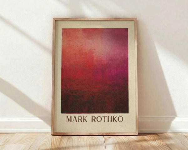 May include: Framed art print featuring abstract gradient from warm orange-red at top transitioning to deep burgundy and dark brown at bottom, displayed in light wood frame with cream matting against white wall on wooden floor with natural sunlight shadows