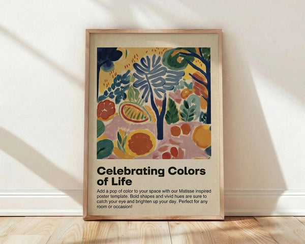 May include: Framed colorful abstract art print leaning against white wall on wooden floor. Artwork features vibrant botanical shapes including tropical leaves, fruits, and flowers in blues, greens, oranges, and reds with Matisse-inspired cut-out style. Light wood frame with cream matting. Text below reads "Celebrating Colors of Life" with product description. Soft natural lighting creates diagonal shadows on wall.