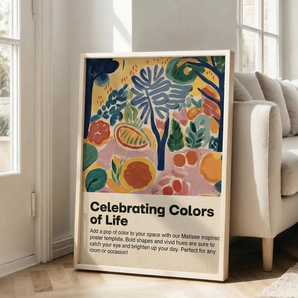 May include: Colorful abstract botanical poster in light wood frame leaning against white wall next to beige couch. Artwork features vibrant blues, greens, oranges, and pinks in painterly style with tropical leaves, flowers, and organic shapes. Text below reads "Celebrating Colors of Life" with description. Bright, airy room with large windows and natural lighting.