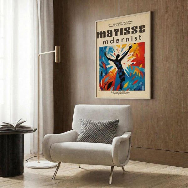 May include: Framed Matisse-inspired modernist poster hanging on wood-paneled wall above beige upholstered armchair with geometric pillow. Artwork features silhouetted dancing figure surrounded by vibrant blue, orange, and yellow abstract shapes. Room setting includes brass floor lamp and side table with open book.