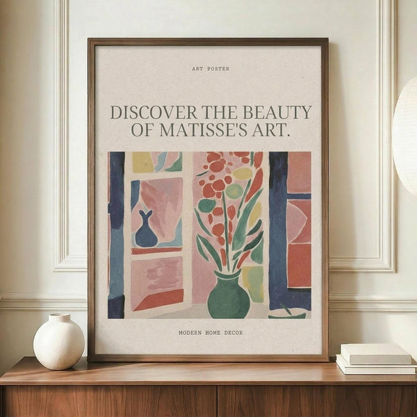 May include: Framed art poster with Matisse-inspired illustration of flowers in a green vase by a window, featuring coral, pink, green and blue colors in cut-out style. Poster displays against cream wall on wooden sideboard next to white ceramic vase and stacked books in minimalist home setting.