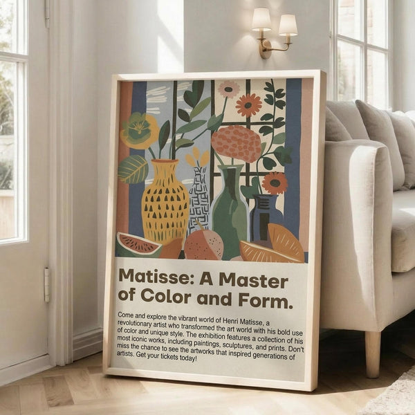 May include: Colorful art exhibition poster with abstract still life showing vases, plants, flowers and fruit in vibrant blues, greens, oranges and yellows. White wooden frame leans against beige wall next to gray sectional sofa in bright living room with large windows and wall sconce lighting.