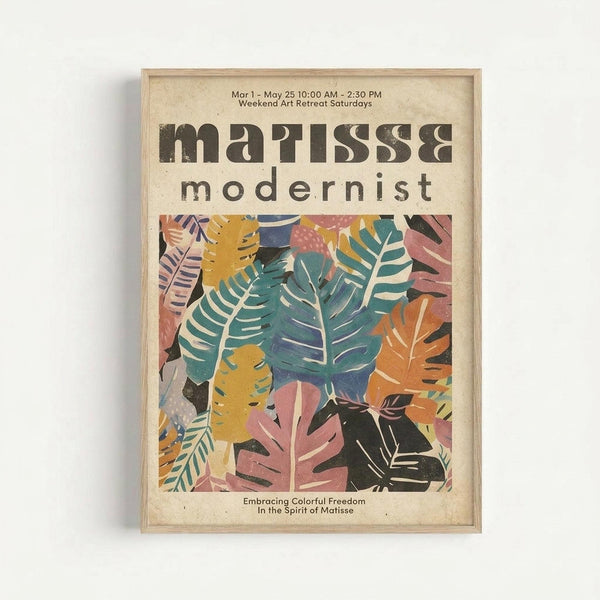 A framed vintage-style poster featuring colorful cut-out leaf shapes in teal, coral pink, golden yellow, and deep navy blue arranged in an overlapping botanical pattern. The cream-colored background shows bold black text reading "matisse & modernist" at the top, with dates and event details. Below the leafy artwork, smaller text reads "Embracing Colorful Freedom In the Spirit of Matisse." The poster is displayed in a light wood frame against a white wall.