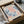 a framed poster of the painting "Matsisse Papiers Découpes" by the artist Berg Gruen, which is a decorative paper with a floral pattern. The poster is placed in a cardboard box, and there is a clear plastic wrapping around it.