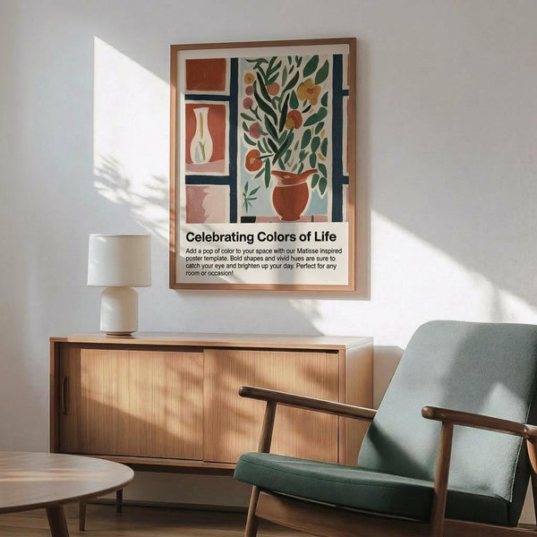 May include: Matisse-inspired poster with colorful still life featuring orange vase with leafy plant, white vase, and geometric shapes in warm terracotta, green, and cream tones. Wooden frame hangs above mid-century modern sideboard with white table lamp. Sage green upholstered chair with wooden arms sits nearby in bright, naturally lit room with white walls.
