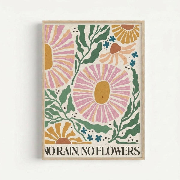 Colorful illustrated poster with stylized flowers in pink, orange, and yellow tones surrounded by green foliage and small blue accent flowers. The artwork features radiating petal patterns and organic botanical elements against a cream background. Text at bottom reads "NO RAIN, NO FLOWERS" in black serif font. Displayed in thin natural wood frame against white wall.