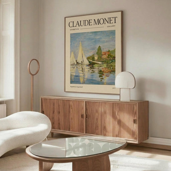 May include: Framed Claude Monet exhibition poster showing sailboats on water in impressionist style, displayed above walnut credenza in minimalist living room with cream chair, glass coffee table, and modern lighting fixtures on neutral walls.