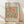 May include: Framed vintage exhibition poster featuring Henri Matisse's cut-out style artwork in organic coral orange and sage green shapes on cream background, displayed against white textured wall on light wood floor with natural shadow patterns