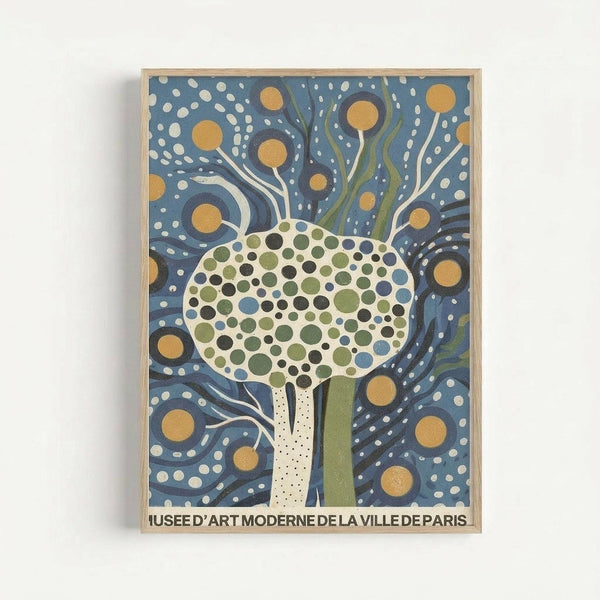 Stylized tree illustration with dotted circular canopy in green, blue and cream tones against swirling dark blue background with golden circles and white dots. The trunk is depicted as a cream-colored hand reaching upward. French museum text appears at bottom. Artwork displayed in light wood frame against white wall in minimalist gallery style presentation.