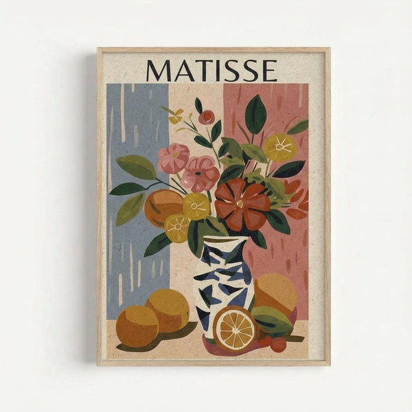 Framed art print in light wood frame showing a Matisse-inspired still life with colorful cut-out style flowers in a blue and white patterned vase, surrounded by orange citrus fruits. Features pink, coral, yellow and green blooms with dark green leaves against a background of blue and coral geometric shapes on cream paper.