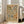 May include: Framed vintage-style botanical poster with earthy tones featuring stylized leaves, plants, and circular sun motifs in greens, oranges, and blues on cream background. White frame leans against wall beside beige sofa in bright room with white walls and large windows.