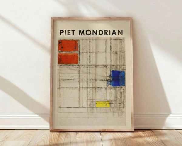 May include: Framed poster print featuring Piet Mondrian's geometric grid composition with red rectangles in upper left, blue square on right side, and yellow rectangle at bottom, all connected by black sketched lines on cream background. Light wood frame leaning against white wall on natural wood floor with soft shadows from window light.