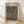 May include: Framed art print featuring Paul Klee's abstract artwork with organic blue and beige shapes on brown background, displayed in light wood frame against white wall on wooden floor with soft natural lighting creating diagonal shadows.