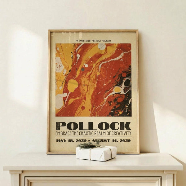 May include: Framed exhibition poster featuring abstract marbled artwork in warm orange, red, and yellow swirls with black accents and white dots. Text reads "POLLOCK" and "EMBRACE THE CHAOTIC REALM OF CREATIVITY" with exhibition dates. Natural wood frame rests on light wooden surface beside small wrapped white gift box with twine and greenery against cream wall.