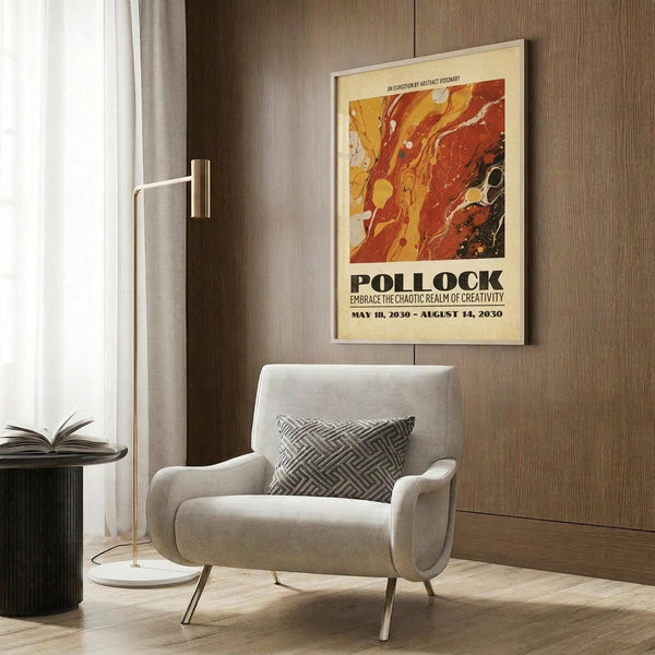 May include: Framed vintage-style exhibition poster with abstract paint splashes in red, orange, and yellow tones, displayed above a cream upholstered armchair with geometric patterned pillow. Modern living room setting features wood paneled wall, brass floor lamp, and dark side table with open book.