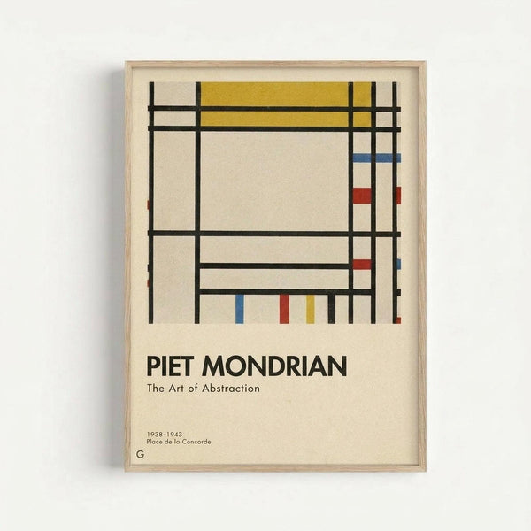 Framed geometric abstract art print featuring black grid lines intersecting to create rectangles, with yellow, red, and blue colored sections on cream background. Text below reads "PIET MONDRIAN The Art of Abstraction" with dates "1938-1943 Place de la Concorde" and a "G" logo. Light wood frame against white wall.