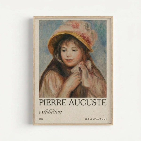 Framed exhibition poster featuring a Renoir painting of a young girl with long brown hair wearing a yellow straw hat with white and pink feathers. The girl holds her hands near her face against a soft blue background. Text reads "PIERRE AUGUSTE exhibition" with "1894" and "Girl with Pink Bonnet" below. The poster is displayed in a light wood frame against a white wall, showing the warm impressionist brushwork and pastel color palette typical of Renoir's style.