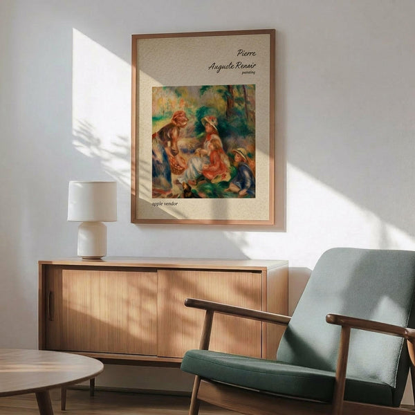May include: Framed Renoir reproduction showing figures in warm oranges and greens with "apple vendor" caption, displayed above wooden sideboard with white lamp in modern living room. Mid-century green upholstered chair with wooden arms sits nearby. Natural sunlight creates geometric shadows on white wall.