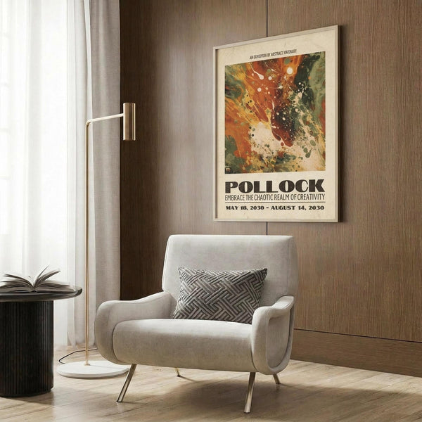 May include: Abstract art poster with vibrant orange, red, green and white paint splatters in Pollock style, displayed in light wooden frame on wood-paneled wall. Modern beige armchair with geometric patterned pillow sits below artwork, next to brass floor lamp and dark round side table with open book.