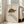 May include: Framed natural history print featuring a detailed illustration of a radiated tortoise with distinctive yellow and black geometric shell patterns on cream background, displayed in light wood frame leaning against white wall next to beige upholstered chair in bright sunlit room with white window frames and hardwood floors.