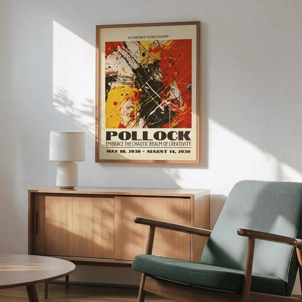 May include: Abstract art poster with dynamic splashes of red, yellow, black and white paint in Jackson Pollock style, framed in thin brown wood frame on white wall above wooden sideboard. Mid-century modern living room setting with sage green upholstered chair with wooden arms, white ceramic table lamp, and natural lighting creating shadows across the scene.