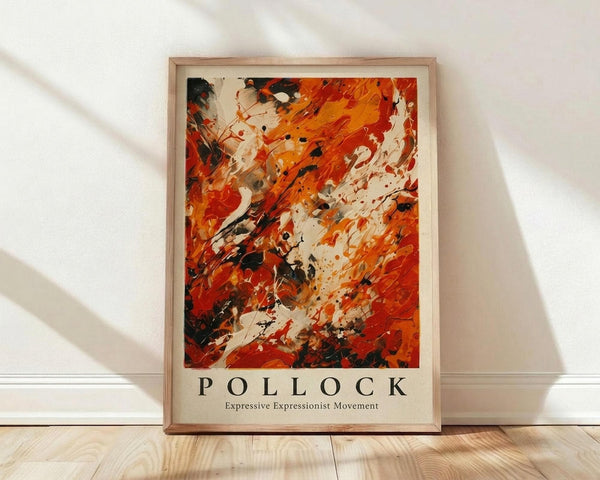 May include: Framed abstract expressionist poster with vibrant orange, red, and black paint splatters and drips on white background, displayed against white textured wall on light wood flooring with natural sunlight creating diagonal shadows across the scene.