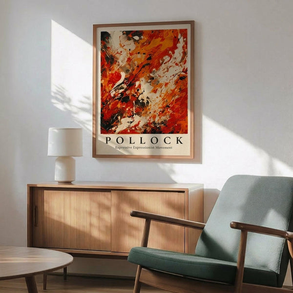 May include: Abstract expressionist artwork with vibrant red, orange, and black paint splatters and drips on white background, displayed in thin wooden frame above mid-century modern wooden credenza. Scene features sage green upholstered armchair with wooden arms, white ceramic table lamp, and circular wooden side table. Warm natural sunlight streams across white wall creating geometric shadows.