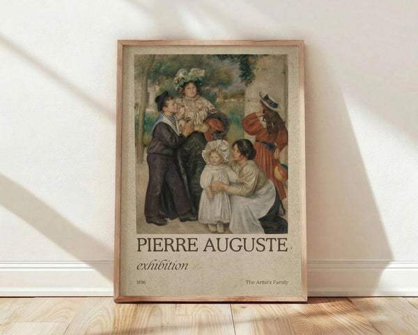 May include: Framed exhibition poster featuring a classical family portrait painting with adults and children in period dress, displayed against white wall on wooden floor. Poster shows "PIERRE AUGUSTE exhibition" text below artwork dated 1896, titled "The Artist's Family." Natural wood frame with beige matting, soft window light creating diagonal shadows across the scene.