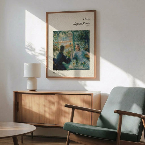 May include: Framed art print of Renoir's impressionist painting showing two figures dining at a restaurant, displayed on white wall above wooden sideboard with table lamp. Mid-century modern green upholstered chair with wooden frame in foreground, natural sunlight creating shadows across the minimalist room setting.