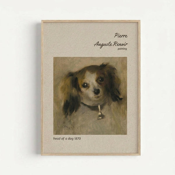 A framed art print featuring Pierre Auguste Renoir's 1870 painting of a small dog's head. The dog has long, fluffy dark ears and expressive eyes, wearing a collar with a small bell. The painting shows warm brown and cream tones with soft brushstrokes typical of Renoir's style. The print is displayed in a simple light wood frame with beige matting, mounted on a white wall. Text identifies the artist and artwork title.