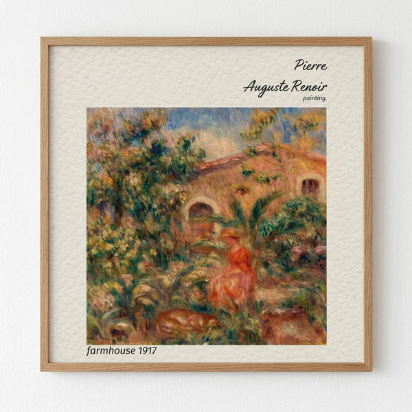 May include: Framed reproduction of Pierre-Auguste Renoir's 1917 farmhouse painting displayed on white textured wall. Light wood frame contains impressionist artwork showing warm orange and coral building with arched windows surrounded by lush green foliage and trees. Soft brushstrokes create dreamy landscape scene with figure in red dress among vegetation. White matting borders the colorful oil painting style print.