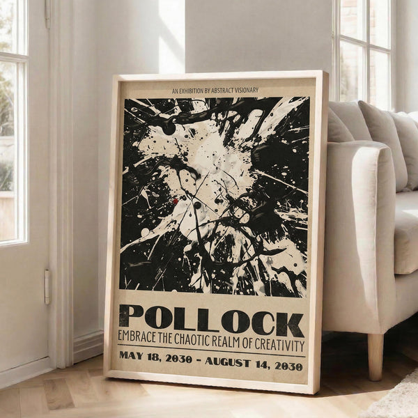 May include: Large framed abstract art poster with black paint splatters and drips on cream background, featuring bold "POLLOCK" text and exhibition details. Poster leans against white wall next to beige upholstered chair in bright living room with tall windows and natural lighting.