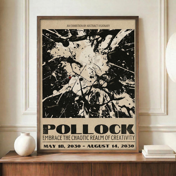 May include: Framed exhibition poster with black and white abstract splatter artwork reminiscent of Jackson Pollock's drip painting style, featuring chaotic paint splatters and dynamic brushstrokes. Text reads "POLLOCK" and "EMBRACE THE CHAOTIC REALM OF CREATIVITY" with exhibition dates. Displayed on wooden sideboard next to white ceramic vase and books in elegant room with cream walls and white molding.