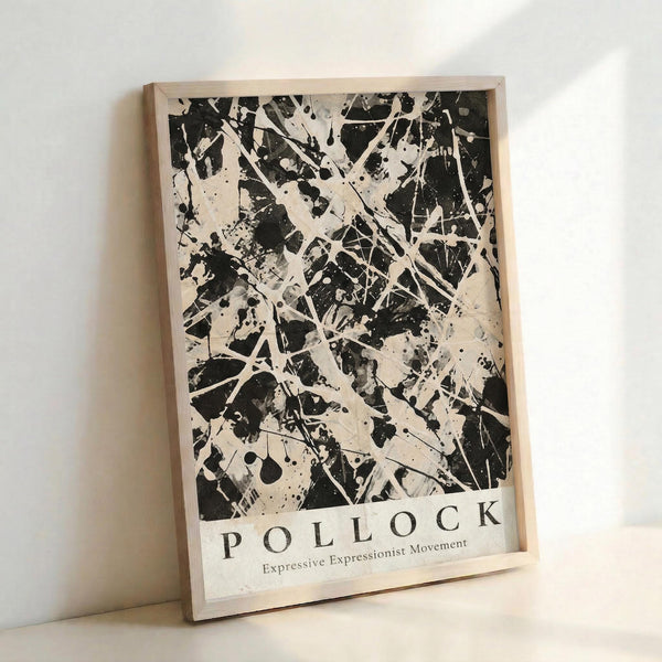 May include: Black and white abstract expressionist art print in light wood frame, leaning against white wall. Features dynamic paint splatters, drips, and gestural marks across cream background. Text at bottom reads "POLLOCK" and "Expressive Expressionist Movement" in clean typography.