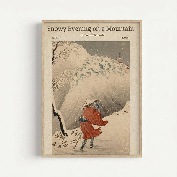 Framed vintage Japanese woodblock print showing a figure in flowing red robes and conical hat walking through heavy snowfall on a mountain path. Snow-covered trees and rocky cliffs dominate the composition, with a small red temple visible on the distant mountainside. The artwork features muted earth tones with falling snow rendered as white dots against the gray sky. Light wood frame against white wall.