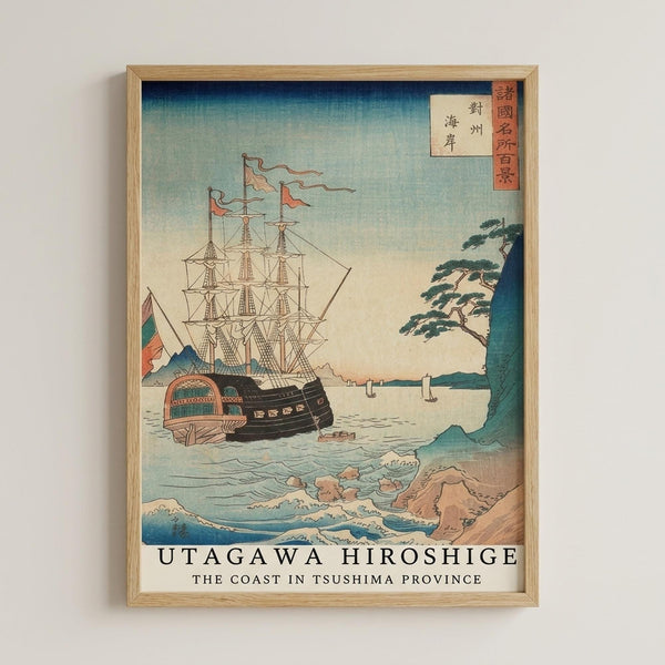 May include: Framed reproduction of a Japanese woodblock print showing a large sailing ship with multiple masts and colorful flags on blue-green water near a rocky coastline with pine trees. The artwork features the characteristic style of ukiyo-e prints with gradient blue sky, detailed rigging, and Japanese text in red cartouches in the upper right corner. Light wood frame against white wall.