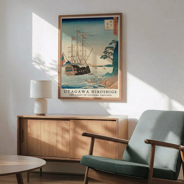 May include: Framed Japanese woodblock print showing sailing ships on blue-green water with coastal landscape, displayed above wooden sideboard with white ceramic lamp in modern living room setting with mint green upholstered chair featuring wooden arms