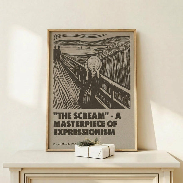 May include: Framed poster featuring Edvard Munch's iconic "The Scream" artwork in black and white with bold text reading "THE SCREAM - A MASTERPIECE OF EXPRESSIONISM" below. The print shows the famous figure with hands to face on a bridge with swirling sky. Displayed on light wood furniture with a small wrapped gift box beside it against a cream wall.