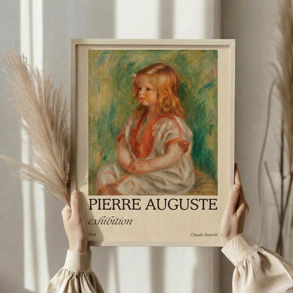 May include: Person in cream ruffled sleeves holding framed vintage art poster featuring young girl with blonde curls in white dress with coral vest, painted in Impressionist style with green-yellow background. Dried wheat stems visible beside frame against soft white curtains.