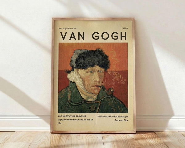 May include: Framed vintage-style poster featuring Van Gogh's self-portrait with bandaged ear and pipe, showing the artist in a green coat and fur hat against an orange background. The cream-colored poster includes museum-style text and is displayed in a light wood frame on wooden flooring against white fabric backdrop with natural lighting creating soft shadows.