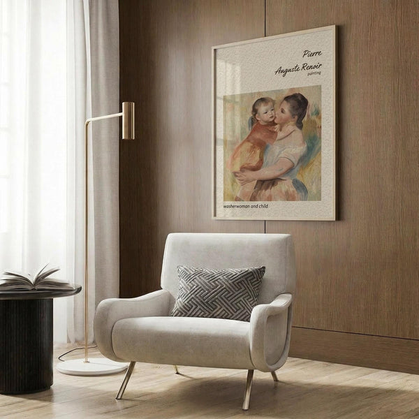 May include: Framed Renoir reproduction poster showing mother holding child in soft pastels, displayed on wood panel wall above cream upholstered armchair with geometric throw pillow. Modern brass floor lamp and dark side table with open book complete the warm, contemporary living space scene.
