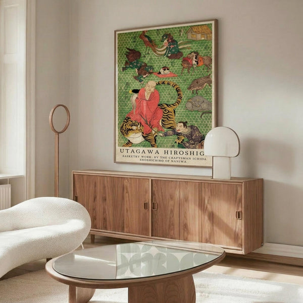 May include: Japanese art poster featuring figures and a tiger on green patterned background, displayed in thin frame above wooden sideboard. Modern living room setting with white curved chair, glass oval coffee table, and minimalist floor lamp. Warm natural lighting creates shadows on white walls.